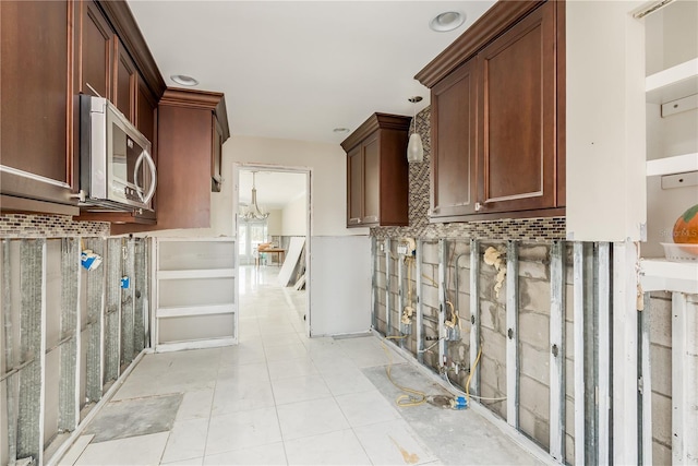 kitchen with backsplash and light tile patterned flooring