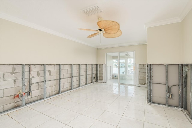 empty room featuring light tile patterned floors, tile walls, and crown molding