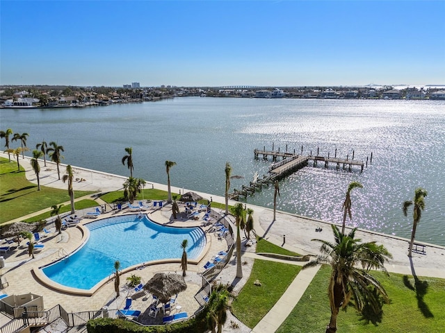 view of pool featuring a water view and a dock