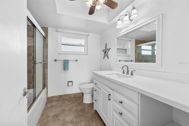 full bathroom with vanity, toilet, a healthy amount of sunlight, and enclosed tub / shower combo