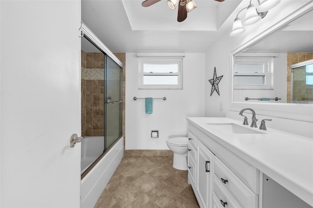 full bathroom featuring combined bath / shower with glass door, ceiling fan, toilet, and vanity