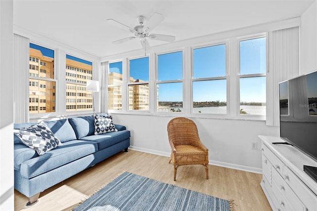 sunroom / solarium featuring ceiling fan