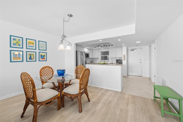 dining space featuring a chandelier and light hardwood / wood-style flooring