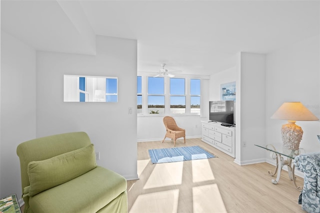 sitting room featuring light wood-type flooring and ceiling fan