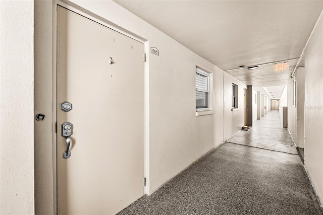 corridor with a textured ceiling