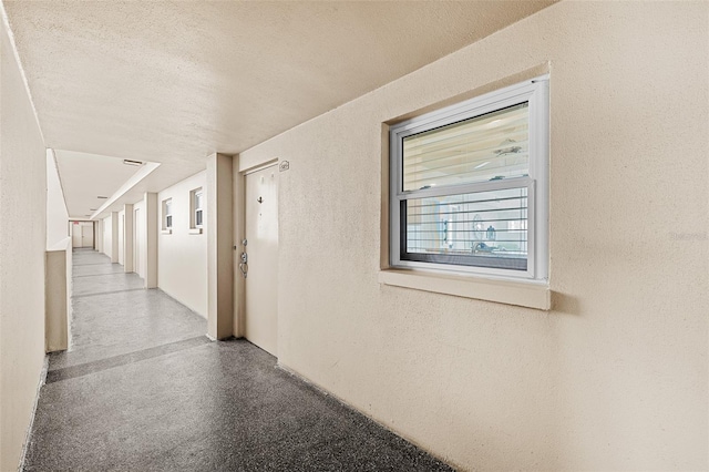 corridor with a textured ceiling