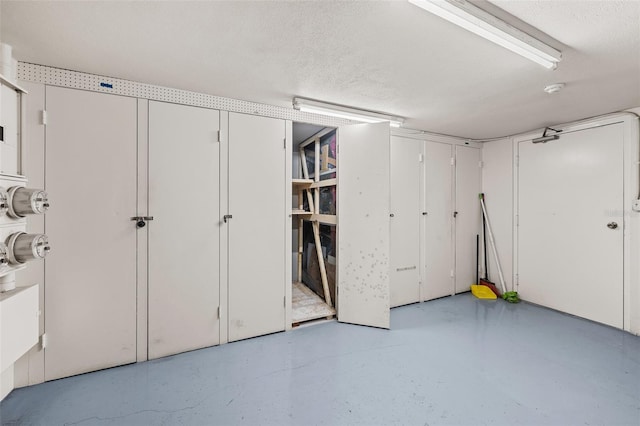 basement featuring a textured ceiling