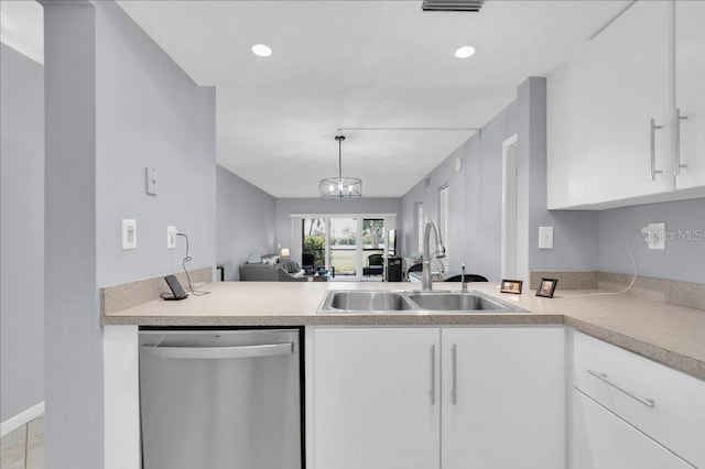 kitchen featuring stainless steel dishwasher, pendant lighting, white cabinetry, and sink