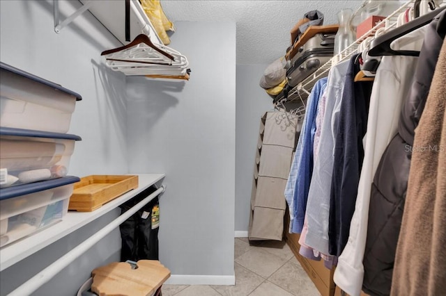 spacious closet featuring light tile patterned flooring