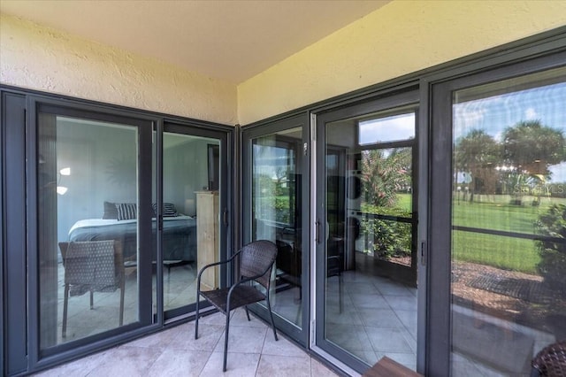 doorway to outside with light tile patterned floors