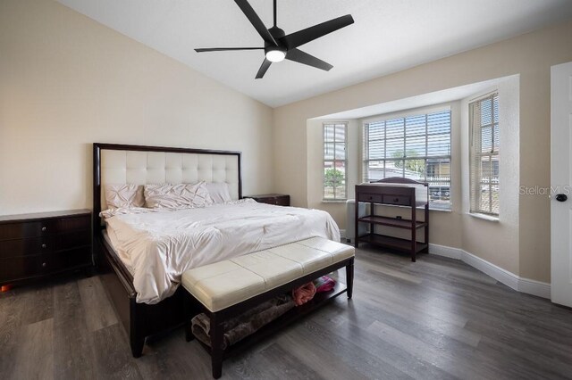 bedroom featuring dark hardwood / wood-style floors, ceiling fan, and lofted ceiling