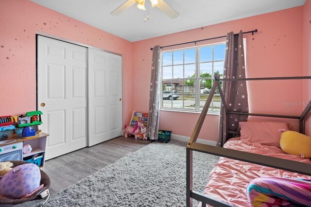 bedroom with a closet, ceiling fan, and hardwood / wood-style floors