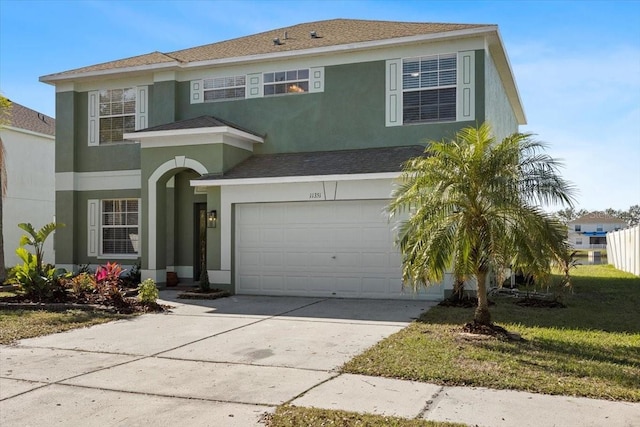 view of front of property with a garage and a front yard