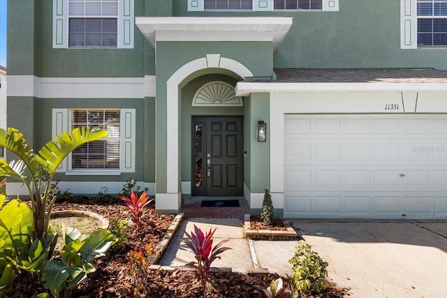 doorway to property with a garage