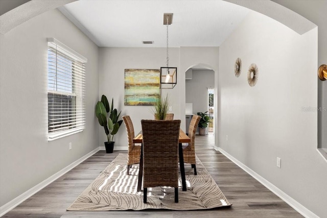 dining area with dark hardwood / wood-style flooring