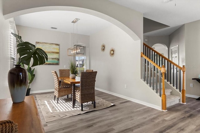 dining area featuring a chandelier and wood-type flooring