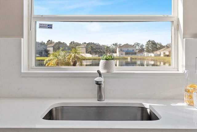 room details featuring a water view and sink