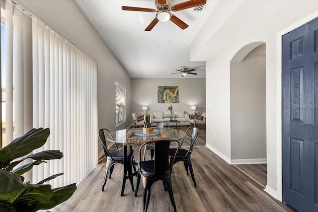 dining space with ceiling fan and hardwood / wood-style floors