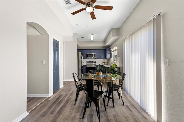 dining space featuring hardwood / wood-style flooring and ceiling fan