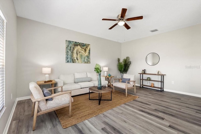 living room featuring hardwood / wood-style flooring and ceiling fan