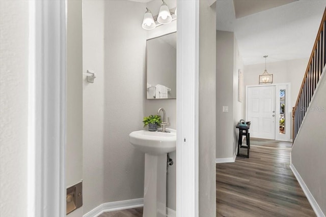 bathroom featuring wood-type flooring and a chandelier