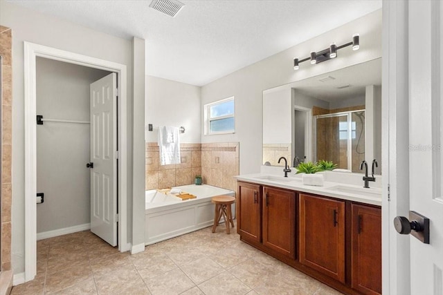 bathroom with tile patterned floors, vanity, and plus walk in shower