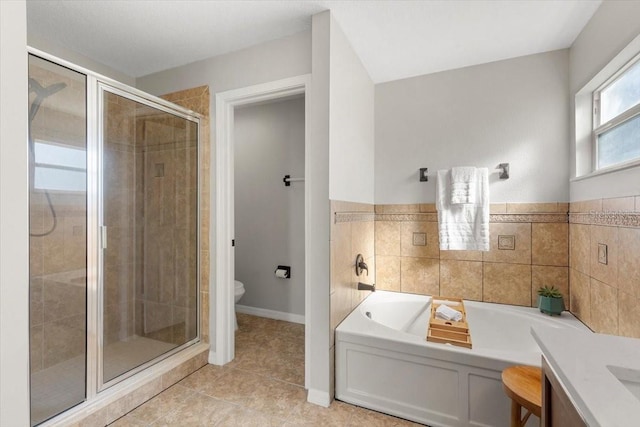 full bathroom with tile patterned floors, vanity, toilet, and independent shower and bath