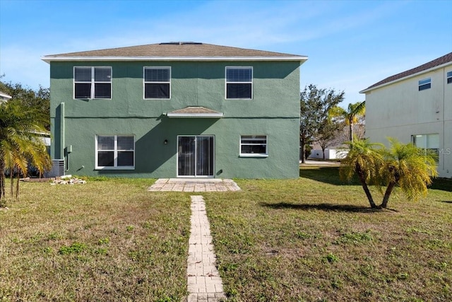 rear view of house featuring a yard