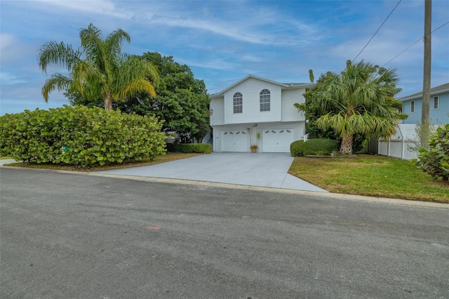 view of front of home featuring a front lawn and a garage