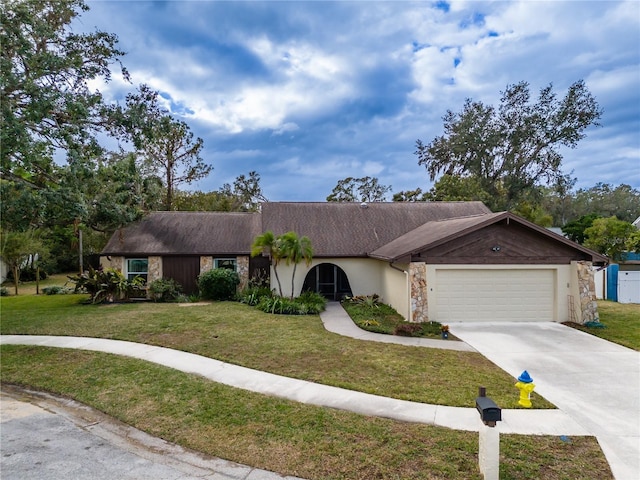 single story home with a garage and a front lawn