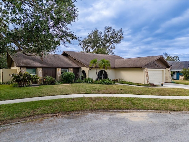 ranch-style house with a garage and a front yard