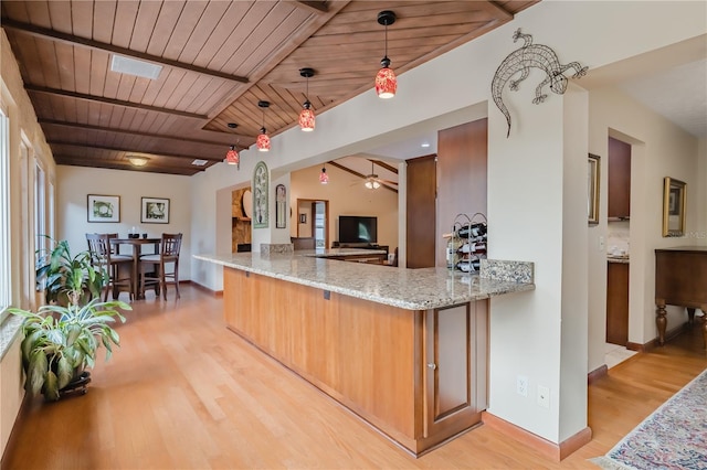 kitchen with light stone countertops, light wood-type flooring, ceiling fan, wooden ceiling, and hanging light fixtures