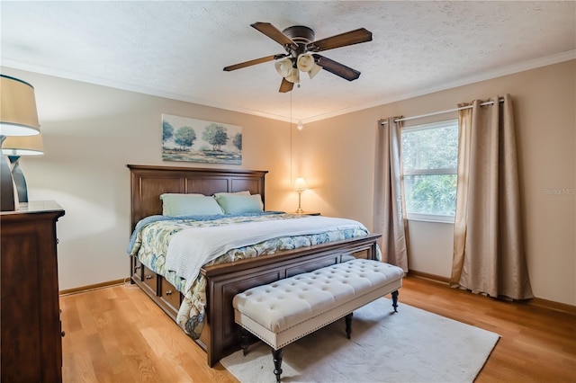 bedroom featuring a textured ceiling, ceiling fan, crown molding, and light hardwood / wood-style flooring