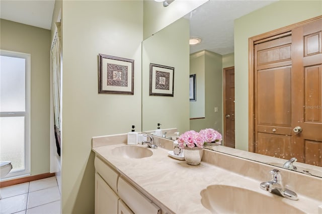 bathroom with tile patterned floors and vanity