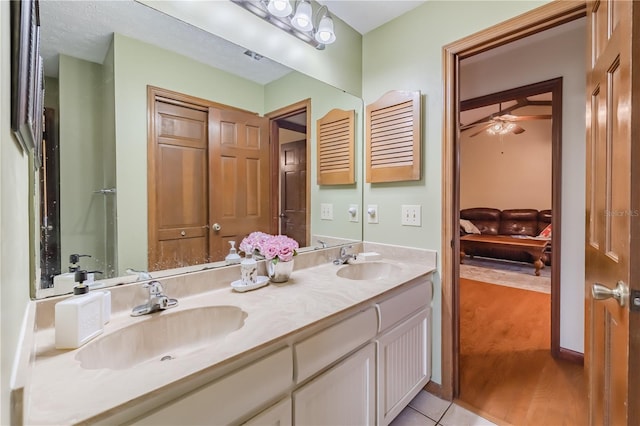 bathroom featuring tile patterned flooring, vanity, and ceiling fan