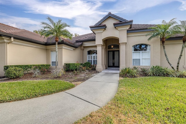 exterior space with a front yard and french doors