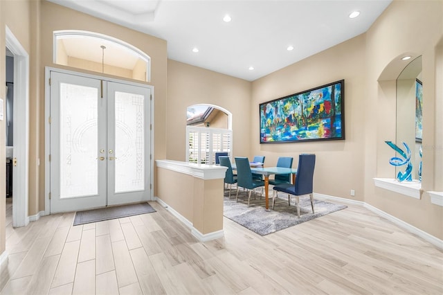 foyer entrance with french doors and light wood-type flooring