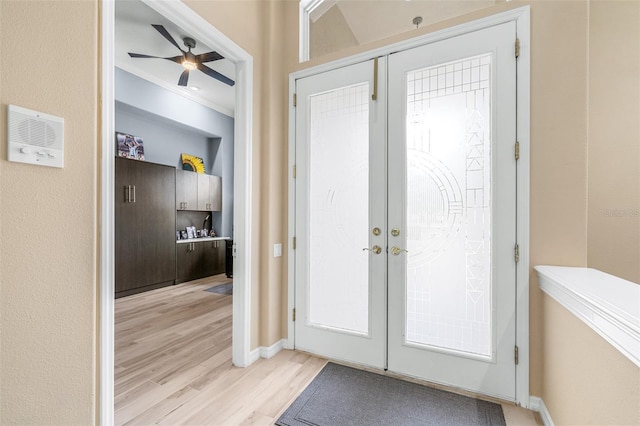 doorway featuring ceiling fan, french doors, light hardwood / wood-style floors, and ornamental molding