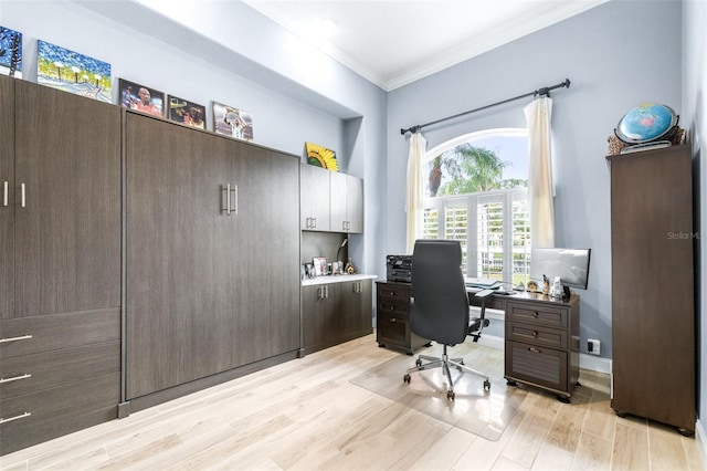 office area with light wood-type flooring and crown molding