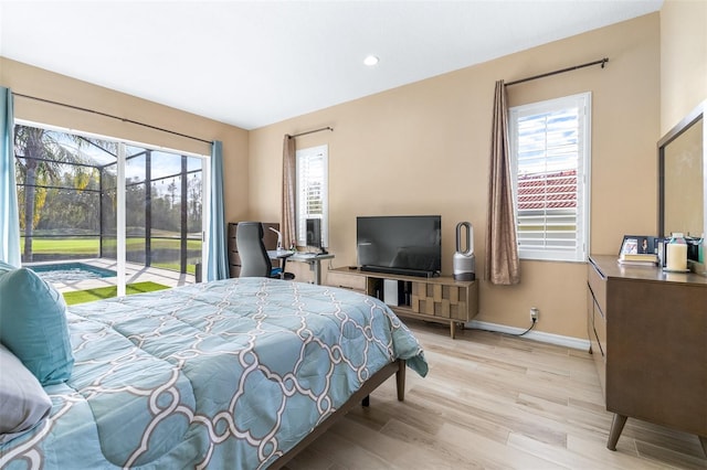 bedroom featuring access to exterior and light hardwood / wood-style flooring