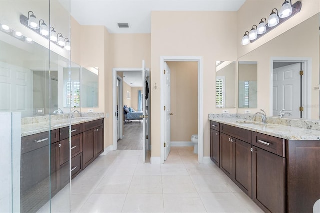 bathroom featuring tile patterned flooring, vanity, and toilet