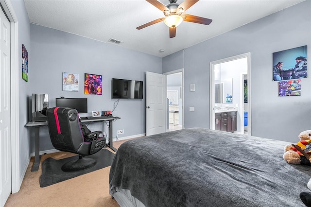 bedroom with connected bathroom, ceiling fan, and light colored carpet