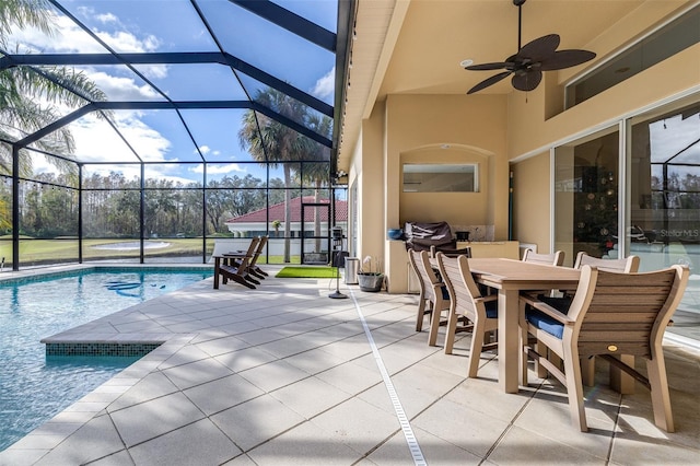 view of patio / terrace featuring ceiling fan and glass enclosure