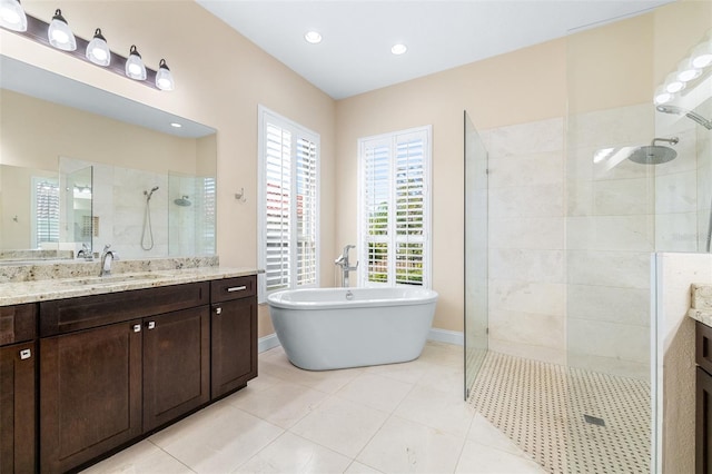 bathroom with tile patterned floors, plus walk in shower, and vanity