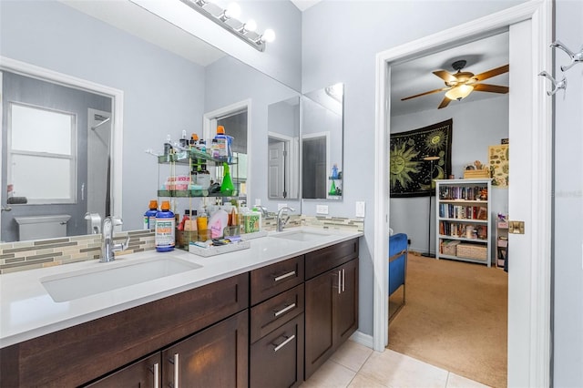 bathroom with ceiling fan, tasteful backsplash, tile patterned floors, toilet, and vanity