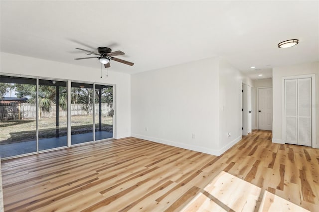 spare room with light hardwood / wood-style flooring and ceiling fan