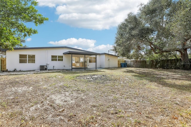 back of house with central AC unit