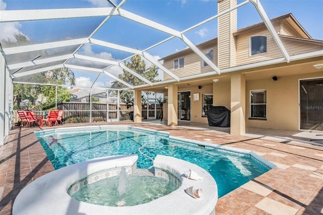 view of swimming pool with a lanai, an in ground hot tub, and a patio