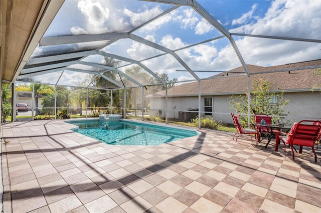 view of pool featuring glass enclosure and a patio area