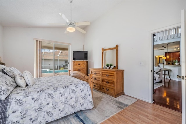 bedroom with ceiling fan, light hardwood / wood-style floors, access to exterior, and lofted ceiling